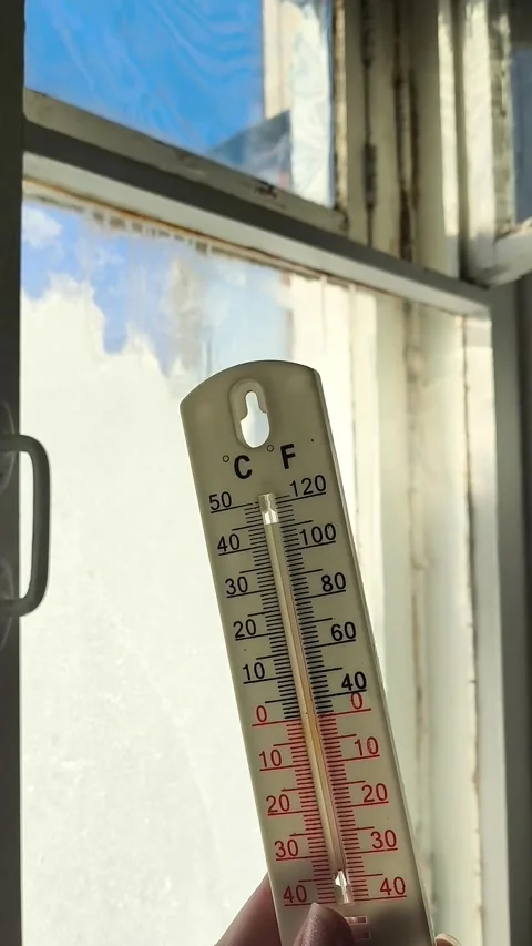 Thermometer for measuring temperature in hand against the background of an old Stock Footage 326735068