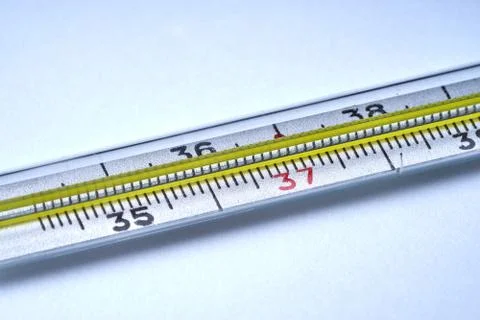 Thermometer for measuring temperature on a white background with texture. Stock Photos