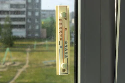 Thermometer outside the window shows a abnormal hot temperature outside Fotos Stock