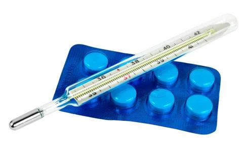 Thermometer with pills isolated Stock Photos