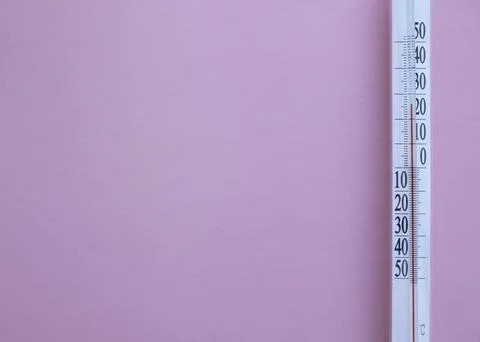 Thermometer on pink background with copy space for your text. Stock Photos