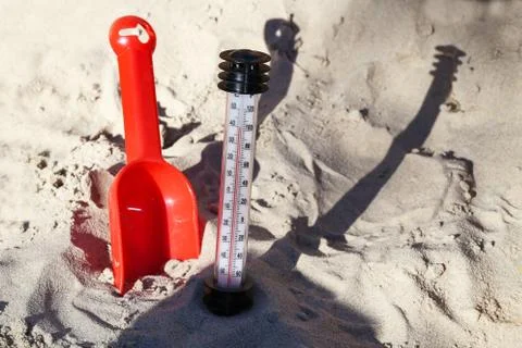 Thermometer in the sand on the beach Stock Photos