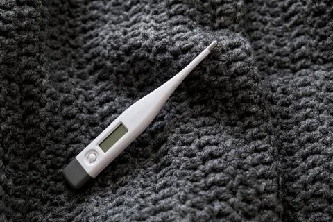 Thermometer on a scarf. Stock Photos