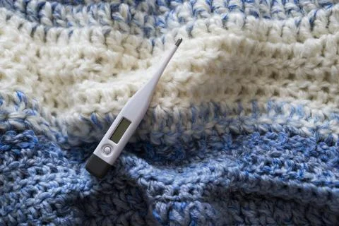 Thermometer on a scarf. Stock Photos