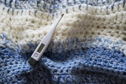 Thermometer on a scarf. Stock Photos