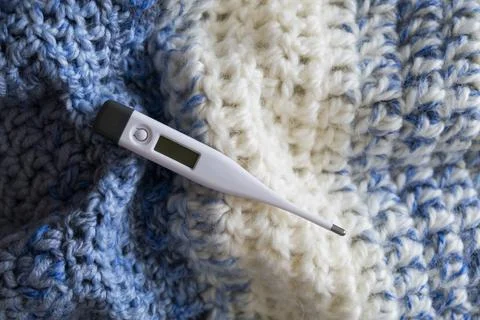 Thermometer on a scarf. Stock Photos