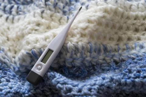 Thermometer on a scarf. Stock Photos