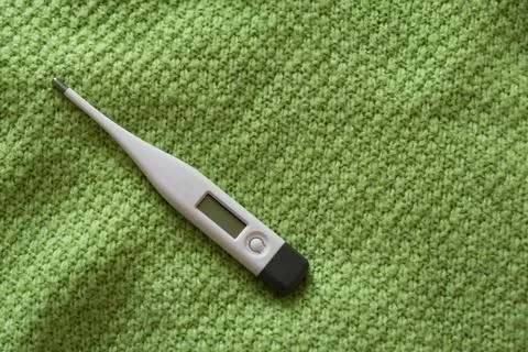 Thermometer on a scarf. Stock Photos
