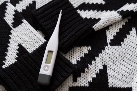 Thermometer on a scarf. Stock Photos