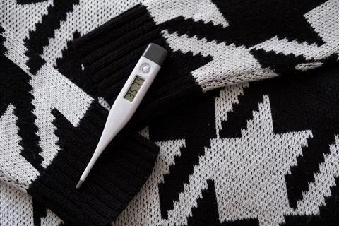 Thermometer on a scarf. Stock Photos