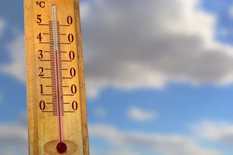 Thermometer showing temperature in degrees Celsius against a bright blue sk.. Stock Photos