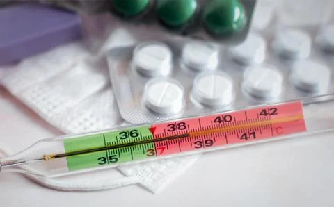 The thermometer shows an elevated temperature for a coronavirus infection Stock Photos