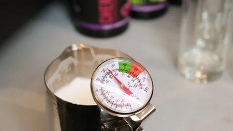 Thermometer shows how the temperature of milk rises Stock Footage 158177872