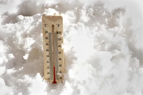 Thermometer in Snow Showing Subzero Temperatures on a Winter Day Photos