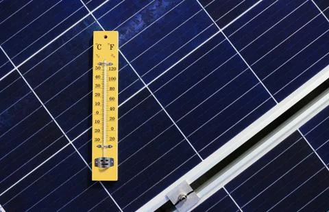 Thermometer on Solar Panel Heat Effect Concept Stock Photos