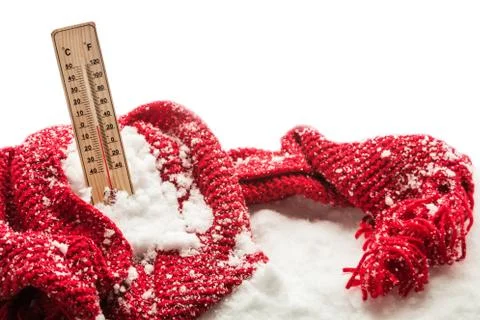 Thermometer with sub zero temperature sticks out in a snowdrift wrapped red Stock Photos