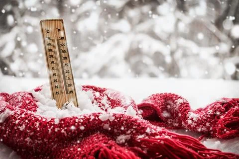 Thermometer with sub zero temperature sticks out in a snowdrift Stock Photos