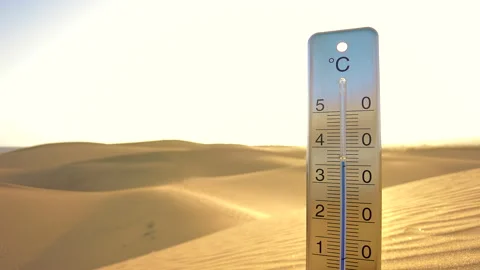 A thermometer, surrounded by endless sand dunes, indicates the climate change. Stock Footage 264802337