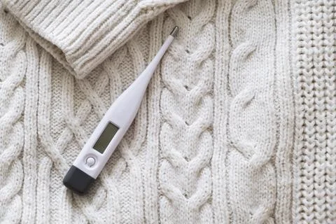 Thermometer on a sweater. Stock Photos