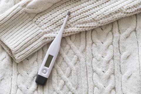 Thermometer on a sweater. Stock Photos