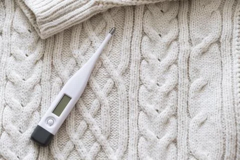 Thermometer on a sweater. Stock Photos