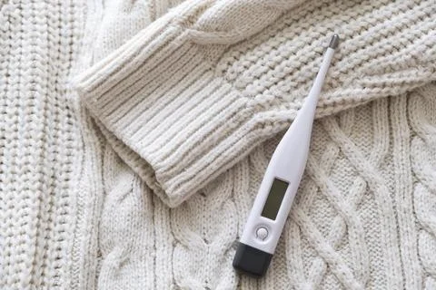 Thermometer on a sweater. Stock Photos