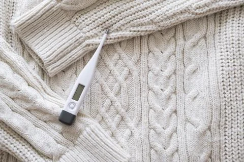 Thermometer on a sweater. Stock Photos