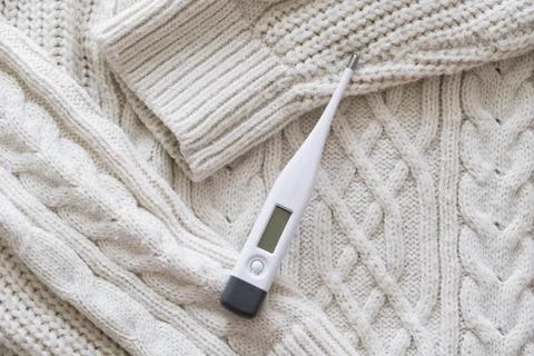 Thermometer on a sweater. Stock Photos