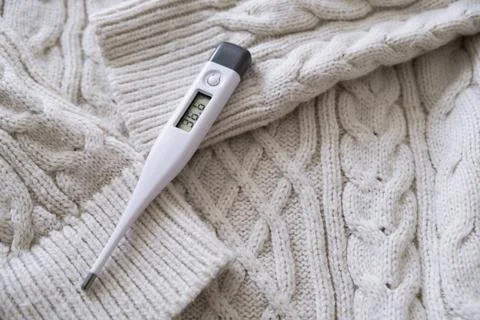 Thermometer on a sweater. Stock Photos