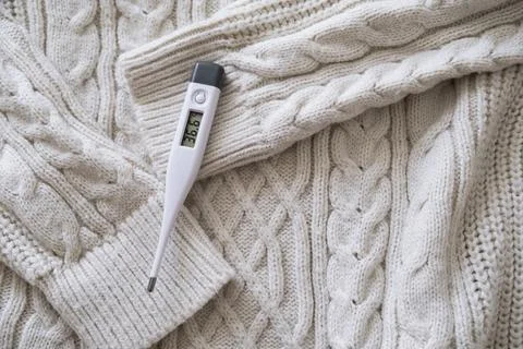 Thermometer on a sweater. Stock Photos