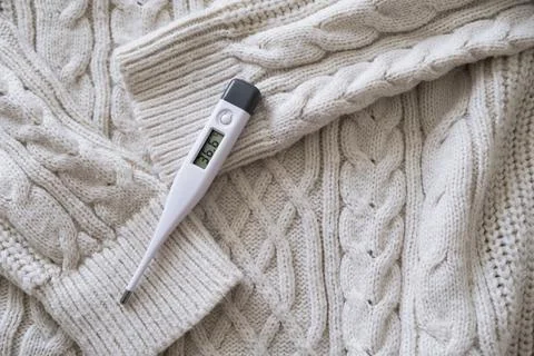Thermometer on a sweater. Stock Photos
