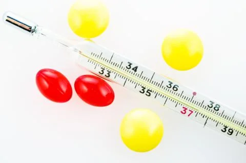 Thermometer with tablets and capsules Stock Photos