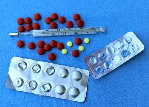 Thermometer with tablets Stock Photos