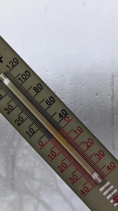 Thermometer in a womans hand against the background of a window with raindrops Stock Footage 326735219