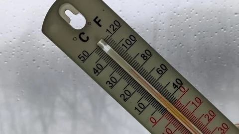 Thermometer in a womans hand against the background of a window with raindrops Stock Footage 326735361