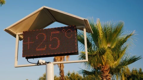 The thermometer's scoreboard on the beach shows the temperature is 25 degrees Stock Footage 123373045