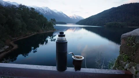 Thermos and Mate Cup Overlooking Patagonian Lake at Dawn Stock Footage 334730530