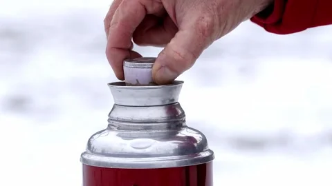 Thermos with hot tea or coffee in a winter snowy forest. Stock Footage 302099091