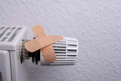 Thermostat with plaster to avoid heating costs Stock Photos