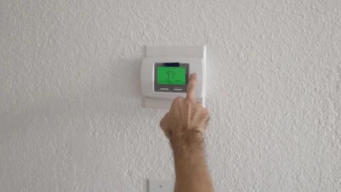 Thermostat temperature control adjusting air conditioning HVAC system close up Stock Footage 331676937