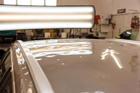 These are the devastating effects that hail can have on cars on the roof. Car is Stock Photos