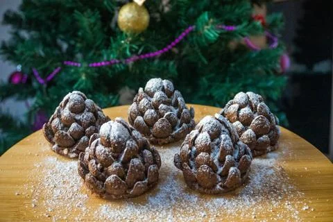 These chocolate pine cone-shaped shortbread cookies with sweet snow. Stock Photos