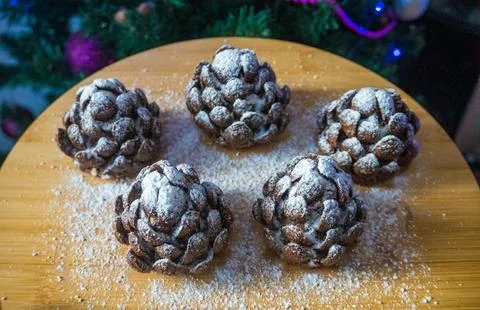 These chocolate pine cone-shaped shortbread cookies with sweet snow. Stock Photos