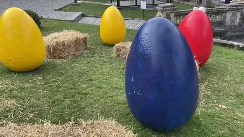 These multi colored eggs decorate the area near the castle. Stock Footage 239616458
