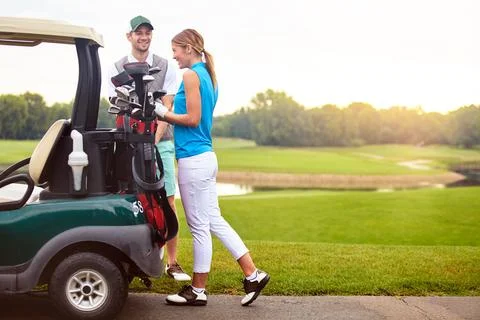 They always have a good time on the golf course. an affectionate young couple Fotos Stock