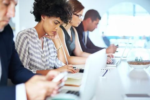 They appreciate the value of hard work. colleagues working at a desk in an Stock Photos