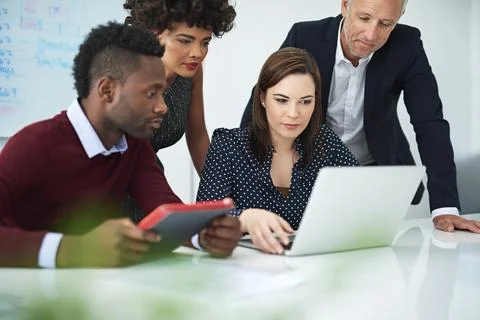 They are the envy of their competitors. a group of businesspeople discussing Stock Photos
