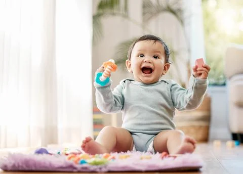 They are the hope and future of this world. an adorable baby playing with toys Stock Photos