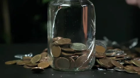 They break a can of change with a hammer, break a can of money, slow motion Stock Footage 264875748