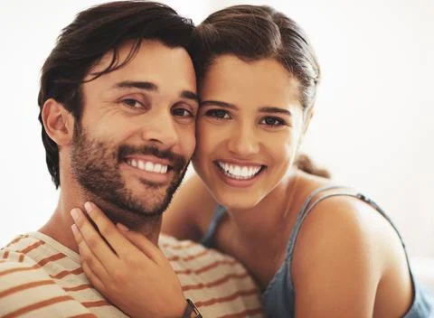 They compliment each other. an affectionate young couple bonding at home. Stock Photos
